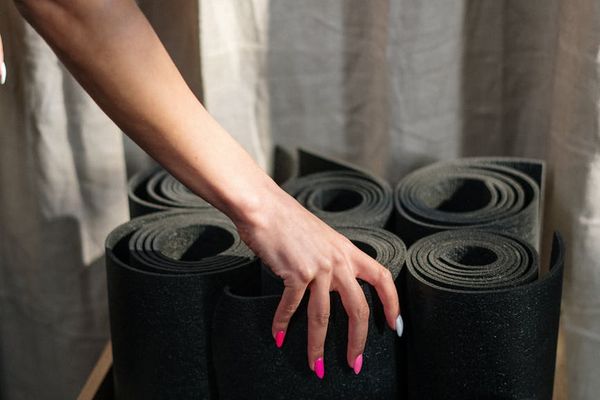Detailed view of yoga mat and accessories in a dark room